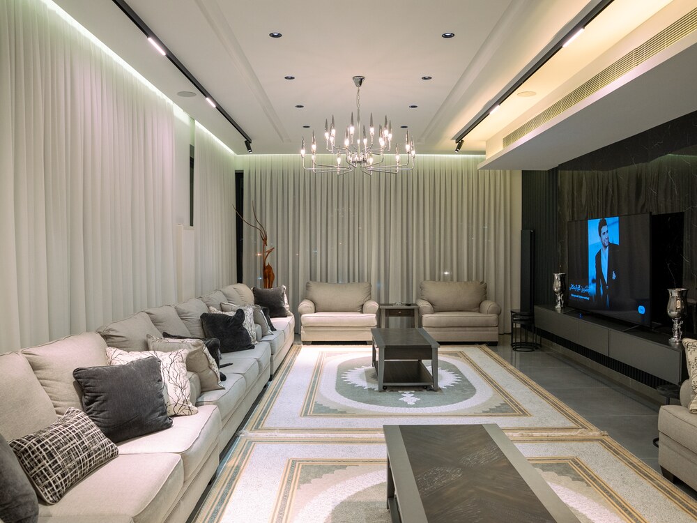 Finished luxury living room with crisp walls and architectural lighting