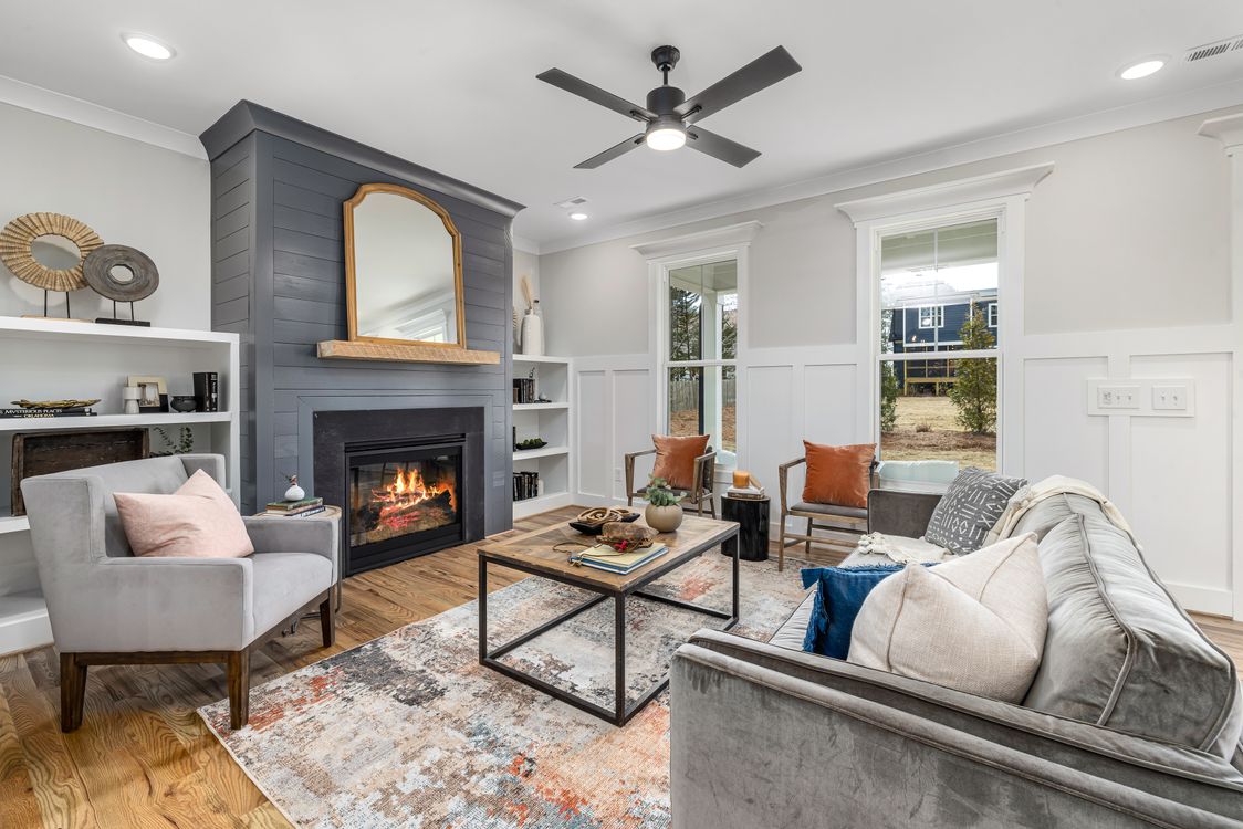 Finished living room with crisp walls, trim, and fireplace details